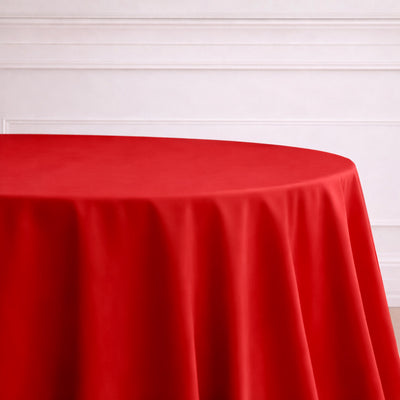 Red round tablecloth on a plain surface.
