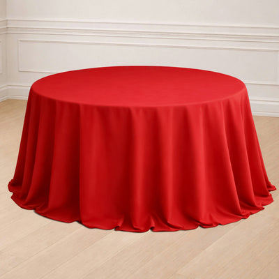 Red round tablecloth draped elegantly over a table in a stylish setting.