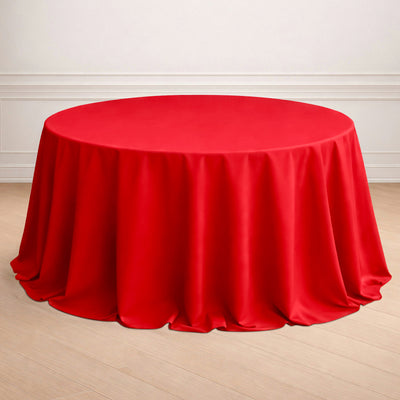 Red round tablecloth draped elegantly over a circular table.