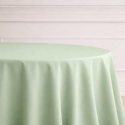 Light green round tablecloth on a neutral background.