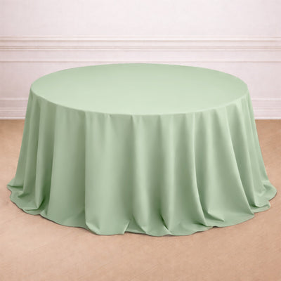 Round mint green tablecloth with elegant draping.