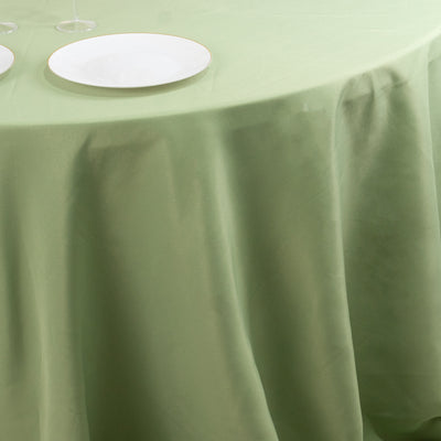 Green tablecloth draped over a table with empty plates.