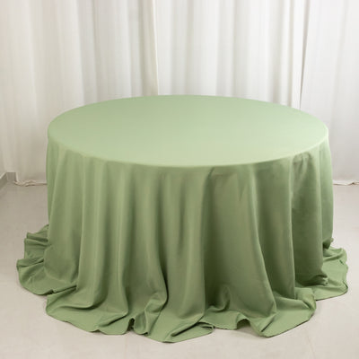 Round green tablecloth draped elegantly over a circular table.