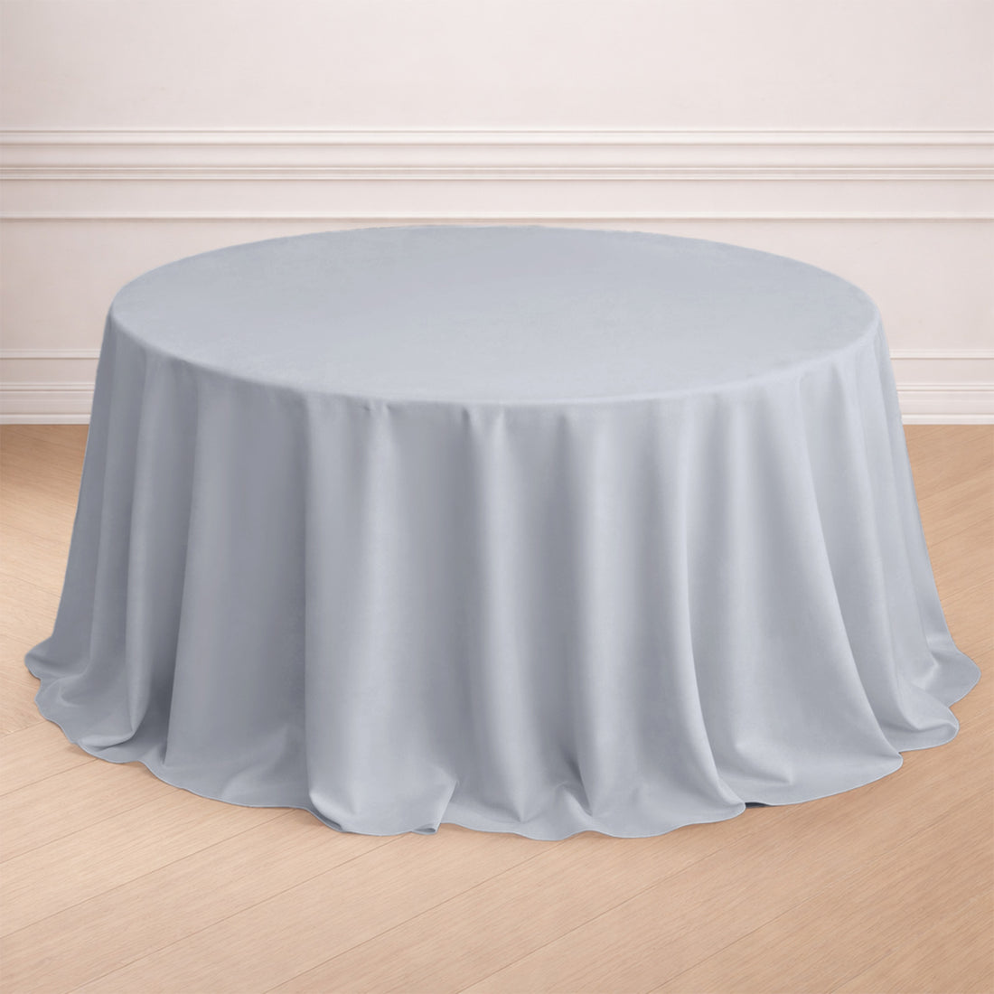 Round light gray tablecloth draped elegantly over a round table.