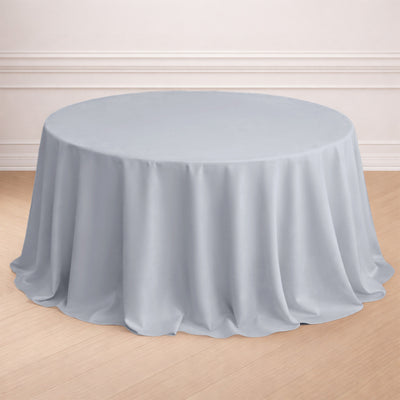 Round light gray tablecloth draped elegantly over a round table.