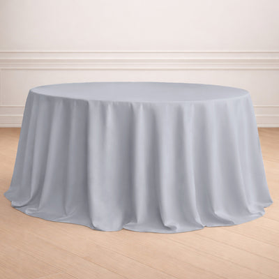 Round gray tablecloth draped over a table in a neutral setting.