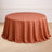 Round terracotta tablecloth draped elegantly over a circular table.