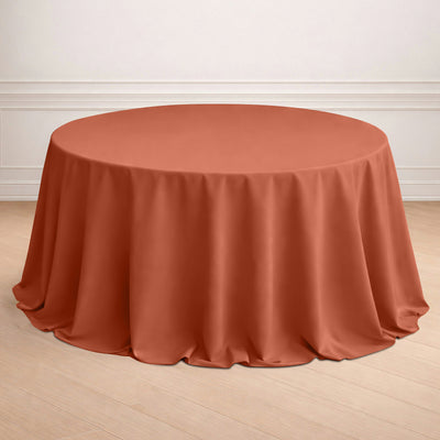 Round terracotta tablecloth draped elegantly over a circular table.
