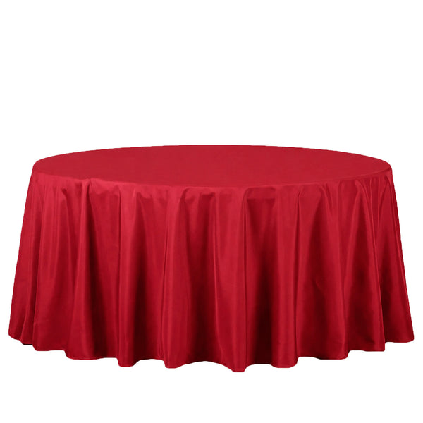 Red round table with satin tablecloth on white background