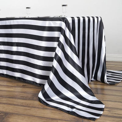 Black and white striped tablecloth draped over a wooden table.