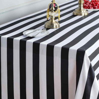 Black and white striped tablecloth on a table with decorative items.