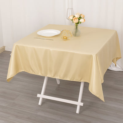 Elegant gold tablecloth draped over a table with a vase of roses.
