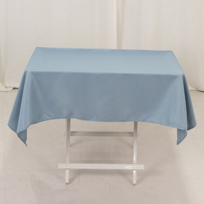 Blue tablecloth draped over a white folding table