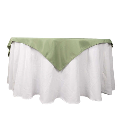 Green tablecloth with white underskirt, styled for elegant dining.