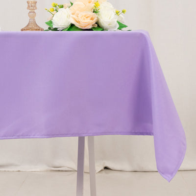Purple tablecloth draped elegantly over a table with decorative flowers.