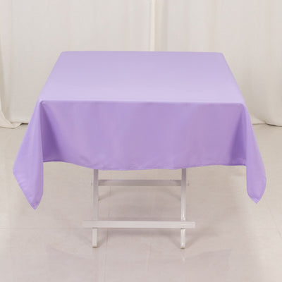 Purple tablecloth on a white table in a studio setting.