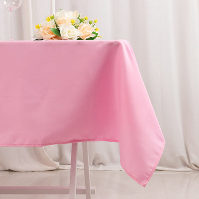 Pink tablecloth draped elegantly over a table with a floral centerpiece.