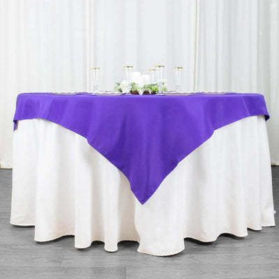 Purple table cover draped over a white tablecloth for elegant events.