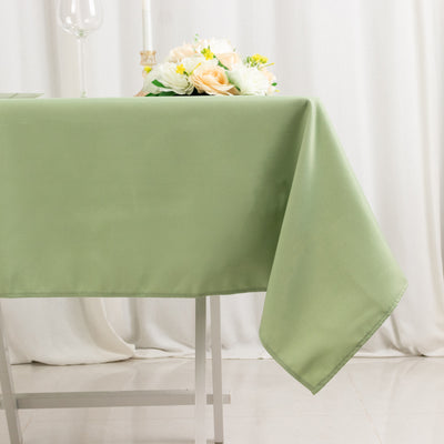 Green tablecloth draped elegantly on a table with floral centerpiece.