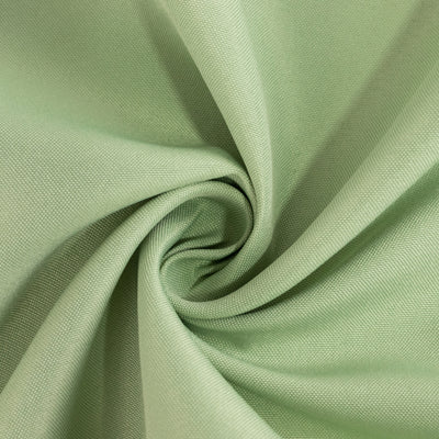 Green fabric texture in a swirling pattern.