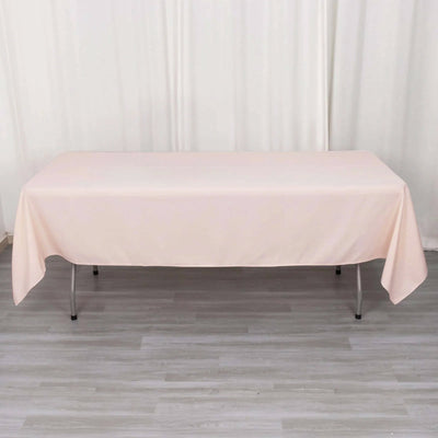 Pink tablecloth draped over a folding table in a studio setting