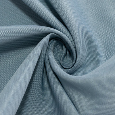 Textured light blue fabric in a swirl pattern.