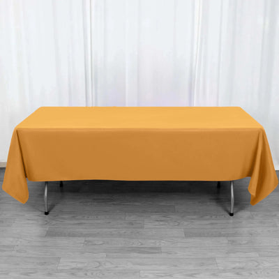 Yellow tablecloth draped over a folding table in a studio setting.