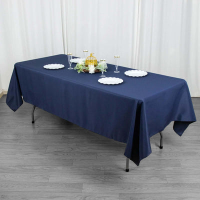 Navy blue tablecloth draped over a table set for a formal event.