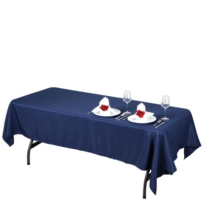Navy blue tablecloth on a dining table set with plates and glasses