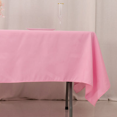 Pink tablecloth draped over a table with elegant decor.