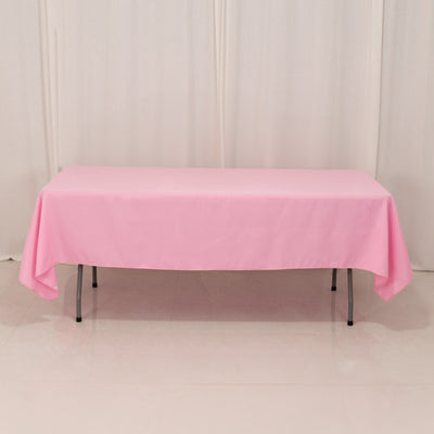 Pink tablecloth draped over a table in a studio setting.