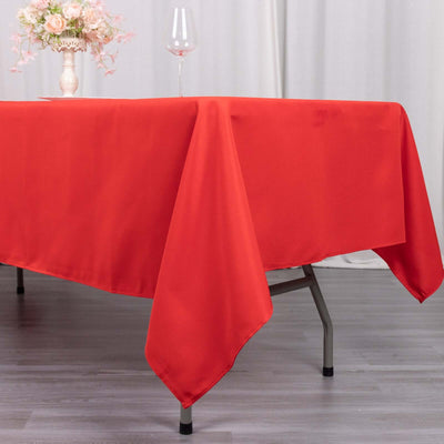 Red tablecloth draped elegantly over a table in a styled setting.