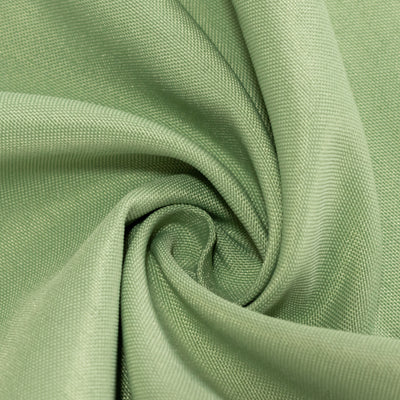 Green fabric texture in a swirling pattern.
