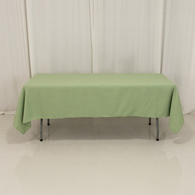 Green tablecloth on a rectangular table in a studio setting.