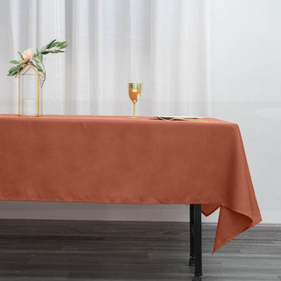 Rust-colored tablecloth draped elegantly over a table in a styled setting.