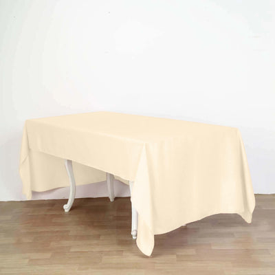 Beige tablecloth draped over a table on a plain background