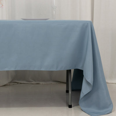 Blue tablecloth draped elegantly over a table with a glass and plate on top.