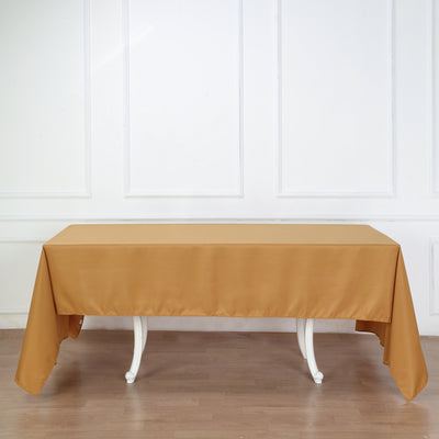 Elegant mustard tablecloth draped over a white table in a bright setting.