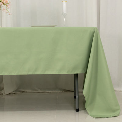 Green tablecloth draped elegantly over a table in a soft setting.