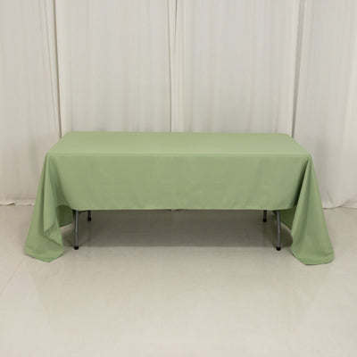 Green tablecloth draped over a long table in a studio setting