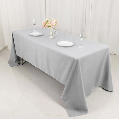 Elegant gray tablecloth draped over a table set for dining.