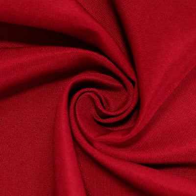 Close-up of red fabric folds with a spiral swirl texture#whtbkgd