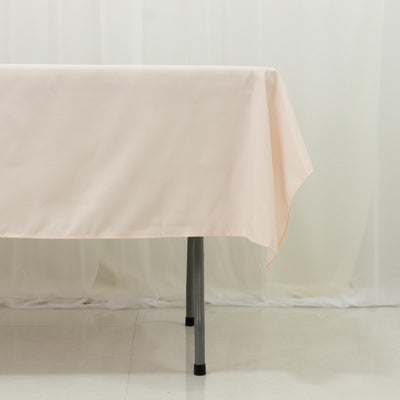 Peach tablecloth draped over a table in a studio setting