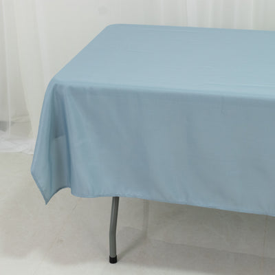 Blue tablecloth draped over a table in a minimalist setting.