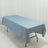 Blue tablecloth draped over a folding table in a studio setting.