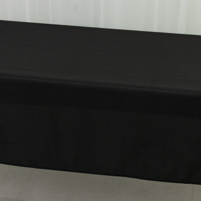 Black tablecloth on a table in a studio setting.