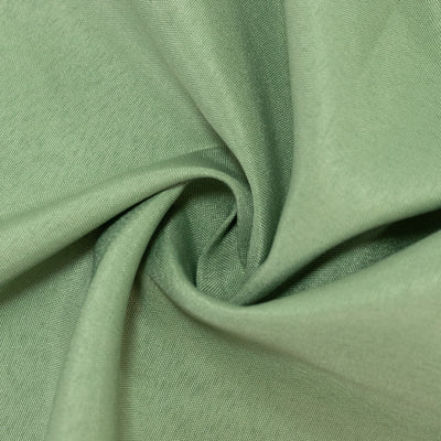 Textured green fabric in a swirl pattern. #whtbkgd