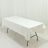 White tablecloth draped over a folding table on a plain background