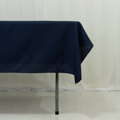 Navy tablecloth draped over a table edge, showcasing fabric texture.