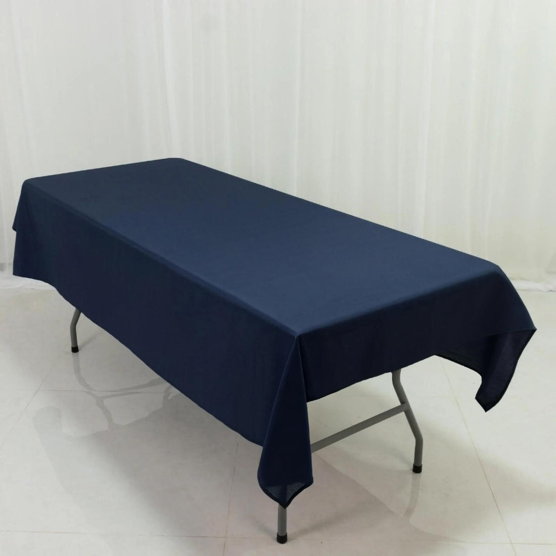 Navy blue tablecloth draped over a folding table